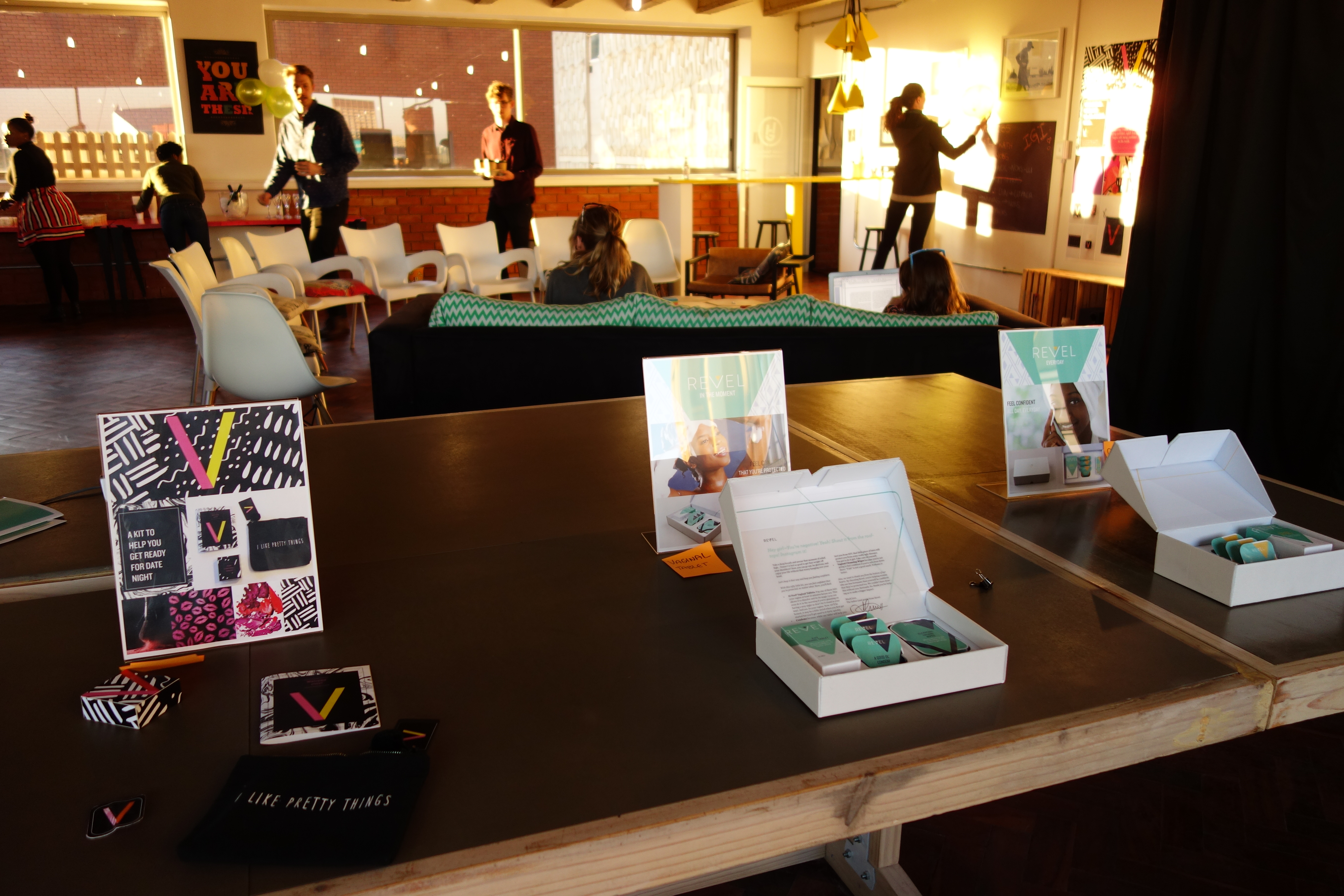 Women sitting on the floor with pamphlets about birth control and safe sex.