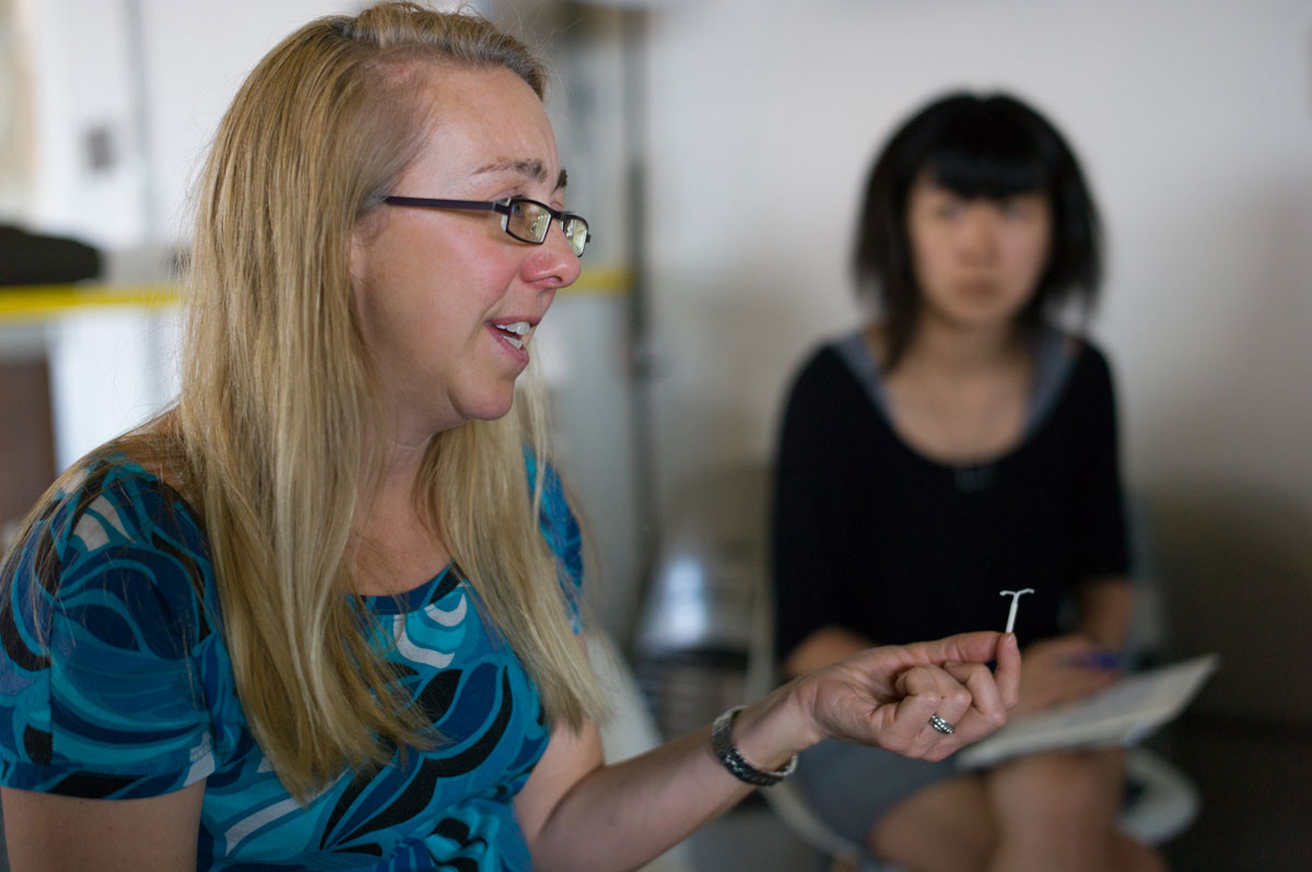 Woman showing an intrauterine device.